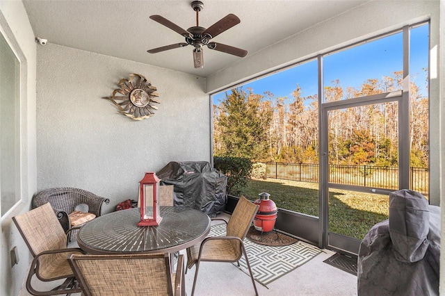 sunroom / solarium featuring ceiling fan