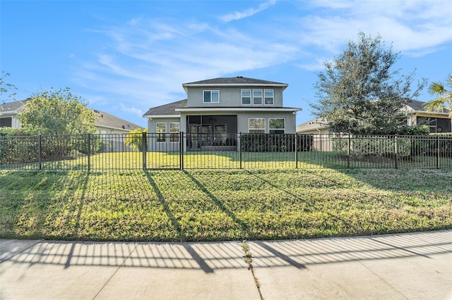 front facade featuring a sunroom and a front lawn