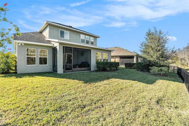 rear view of property featuring a lawn and a sunroom