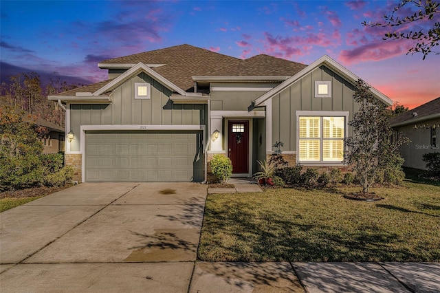 view of front of house with a garage, concrete driveway, board and batten siding, and a lawn