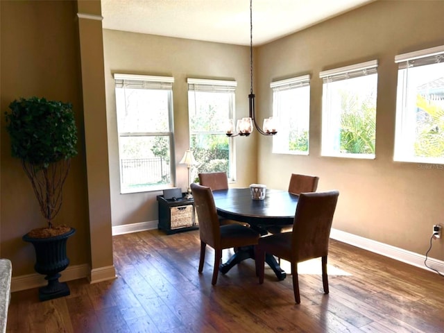 dining room featuring dark wood-style floors, baseboards, and a wealth of natural light