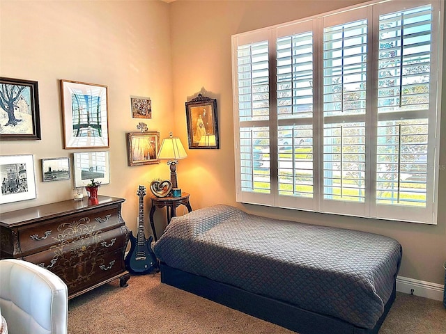 carpeted bedroom with multiple windows and baseboards