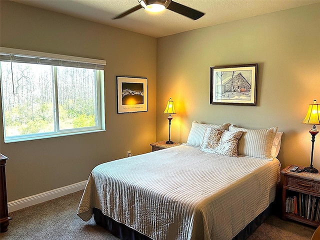 bedroom featuring carpet, baseboards, ceiling fan, and a textured ceiling