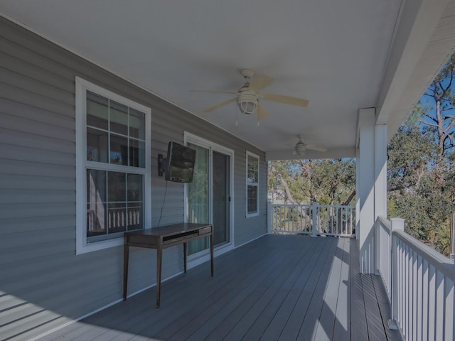 wooden deck featuring ceiling fan