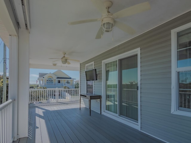 wooden deck featuring ceiling fan