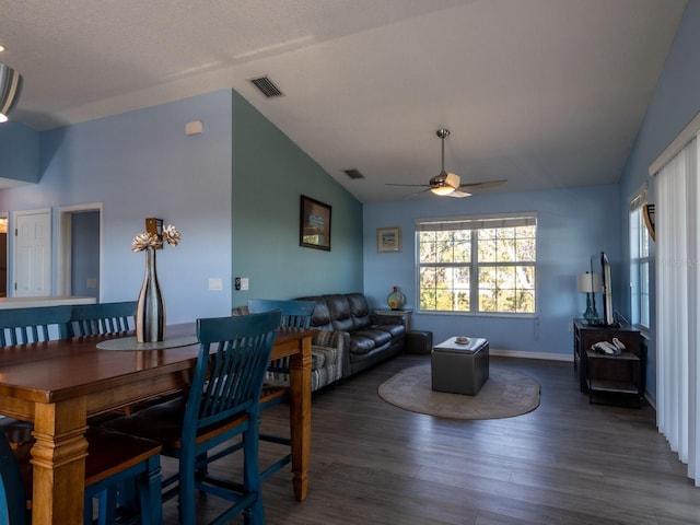 dining area featuring ceiling fan, lofted ceiling, and dark wood-type flooring