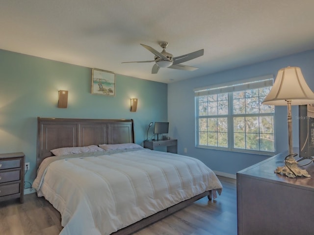 bedroom featuring ceiling fan and dark wood-type flooring