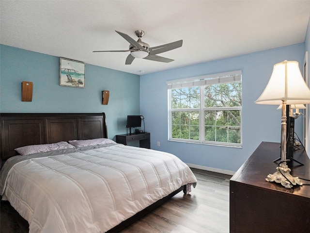 bedroom with light wood-type flooring and ceiling fan