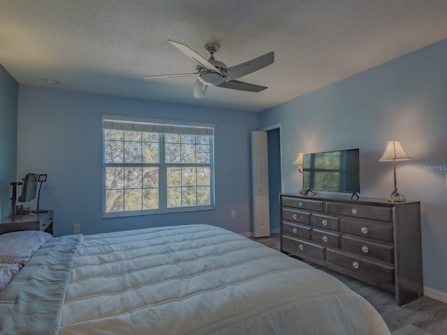 bedroom with ceiling fan and light hardwood / wood-style floors