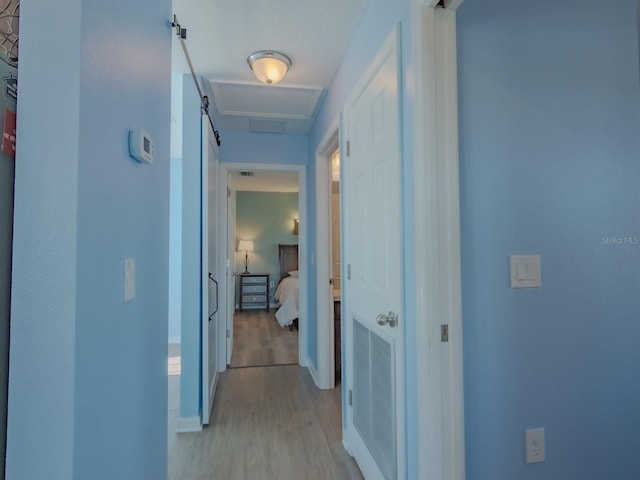 corridor with light hardwood / wood-style flooring