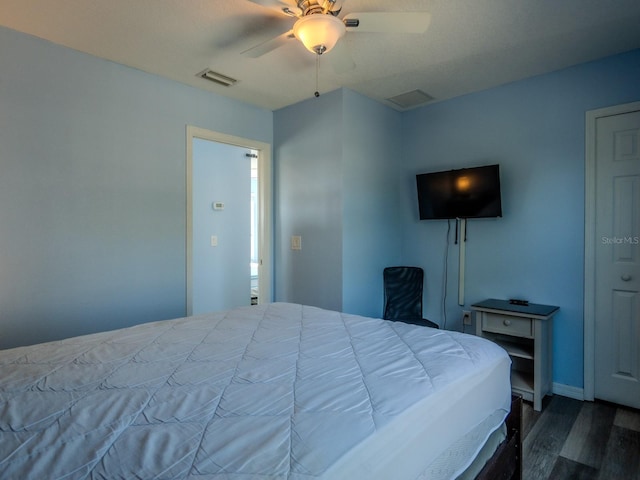 bedroom with ceiling fan and dark wood-type flooring