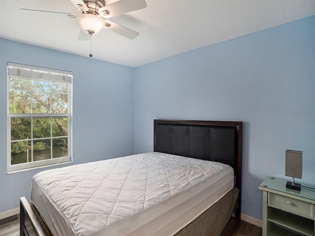 bedroom featuring hardwood / wood-style flooring and ceiling fan