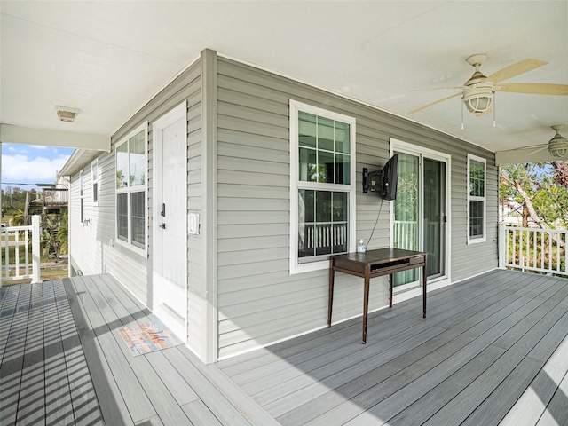 wooden deck featuring ceiling fan