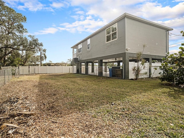 back of property with a lawn