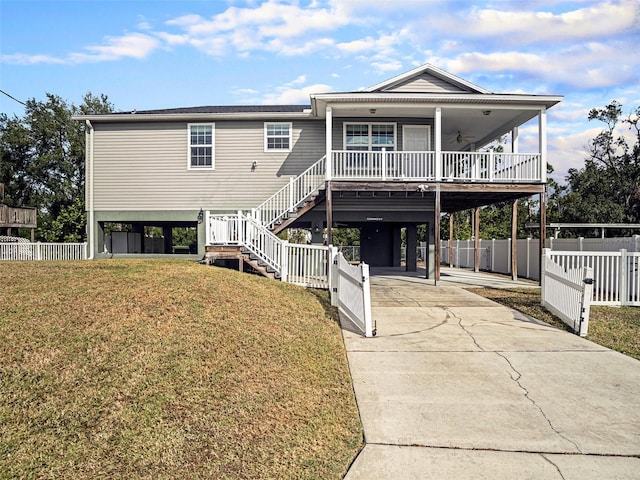 exterior space featuring a yard, covered porch, and a carport