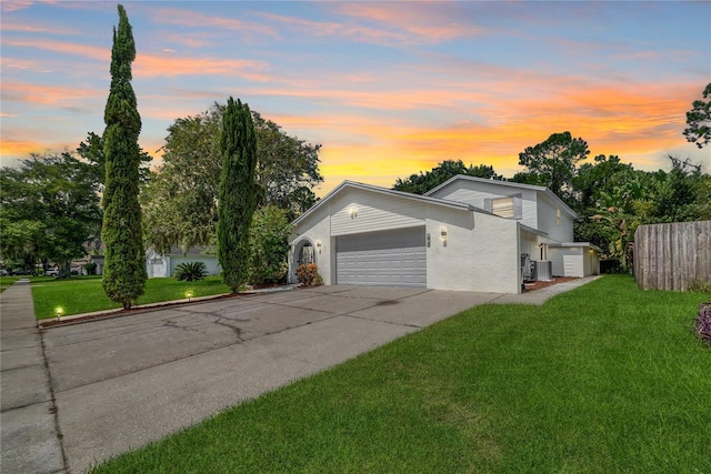 view of front of house with a garage and a yard