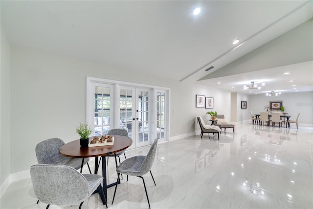 dining area with lofted ceiling and french doors