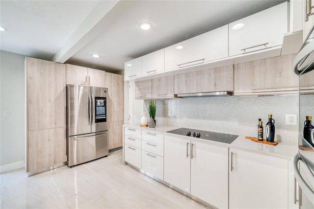 kitchen with ventilation hood, white cabinets, black electric cooktop, and stainless steel refrigerator