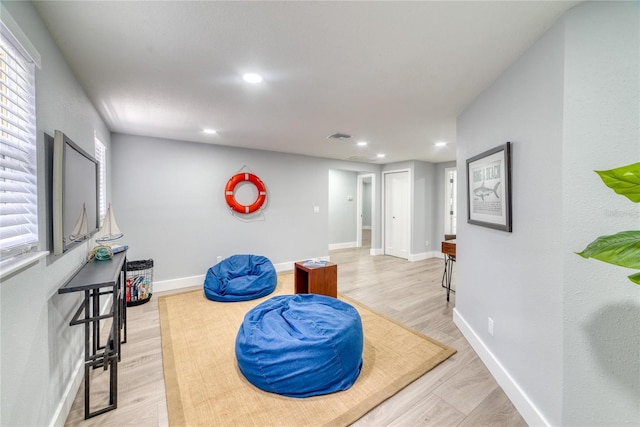 living area with light hardwood / wood-style flooring