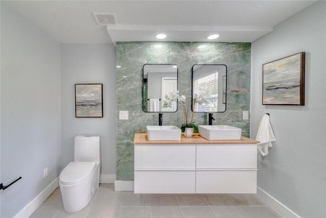 bathroom featuring tile patterned floors, vanity, and toilet