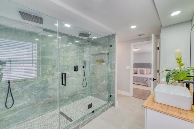 bathroom featuring tile patterned floors, vanity, and an enclosed shower