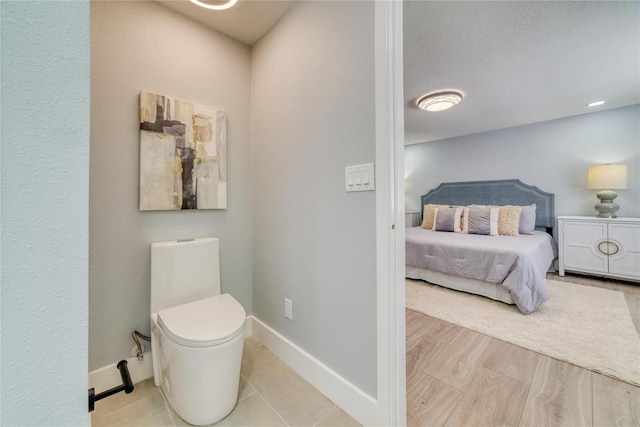 bathroom featuring toilet and a textured ceiling