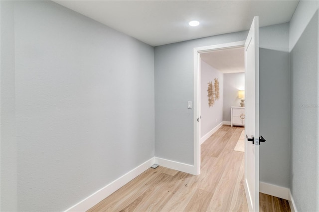 corridor with light wood-type flooring