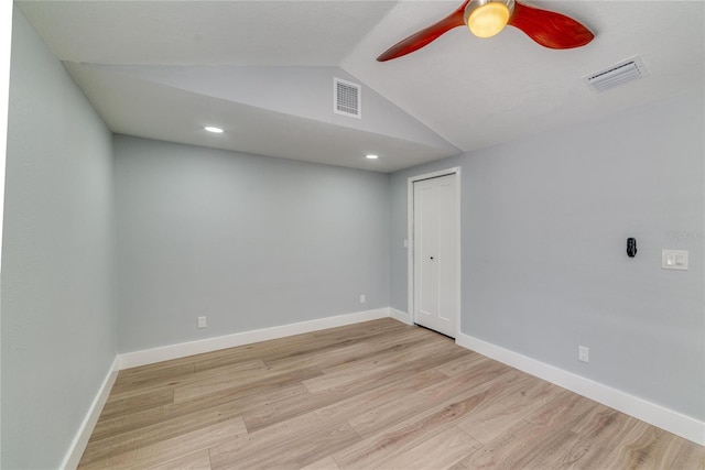 spare room featuring ceiling fan, light hardwood / wood-style floors, and lofted ceiling