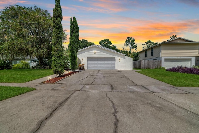 view of front of house with a garage and a lawn