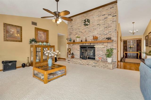 living area with a fireplace, visible vents, high vaulted ceiling, baseboards, and ceiling fan with notable chandelier