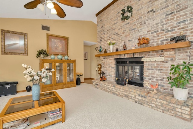 carpeted living area with baseboards, visible vents, a ceiling fan, lofted ceiling, and a brick fireplace