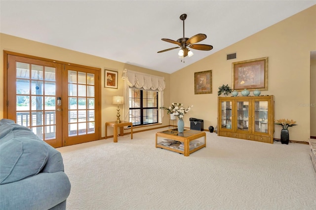 living area with carpet, french doors, lofted ceiling, visible vents, and a ceiling fan