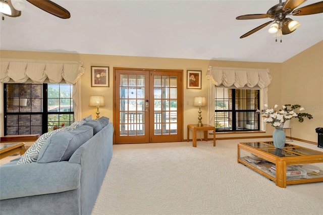 living area featuring carpet floors, lofted ceiling, a ceiling fan, and french doors