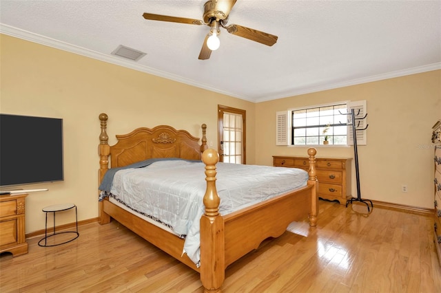 bedroom with ceiling fan, ornamental molding, a textured ceiling, and light hardwood / wood-style flooring