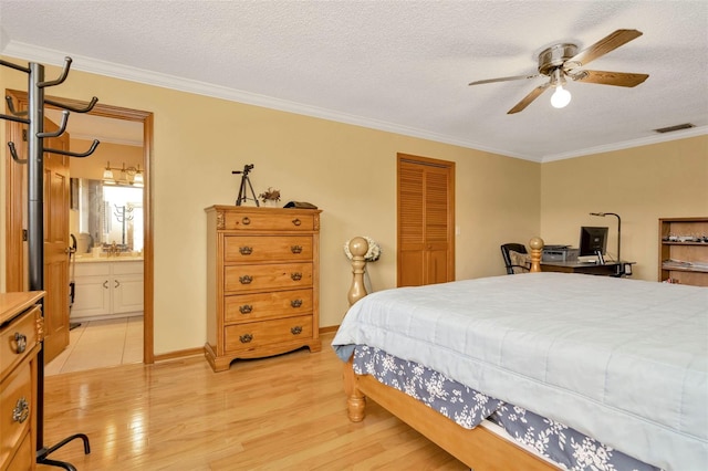 bedroom with light wood-style floors, visible vents, crown molding, and a textured ceiling