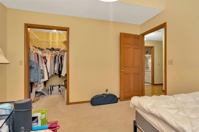 carpeted bedroom featuring a spacious closet and a closet