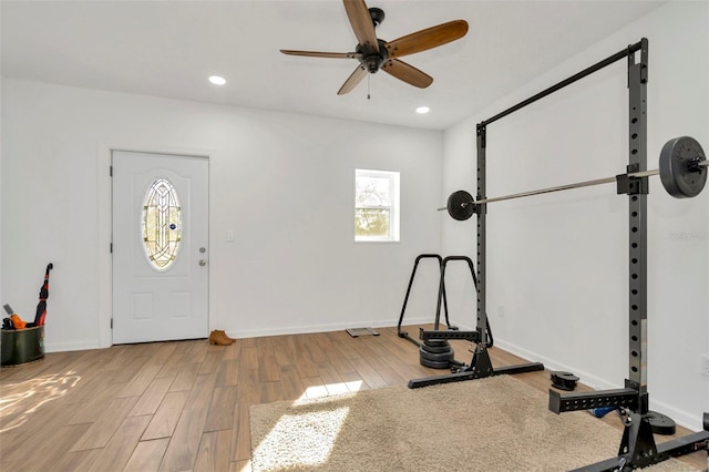 exercise room featuring a ceiling fan, recessed lighting, light wood-style flooring, and baseboards