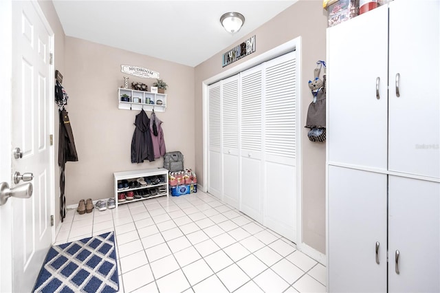 mudroom featuring baseboards and light tile patterned flooring