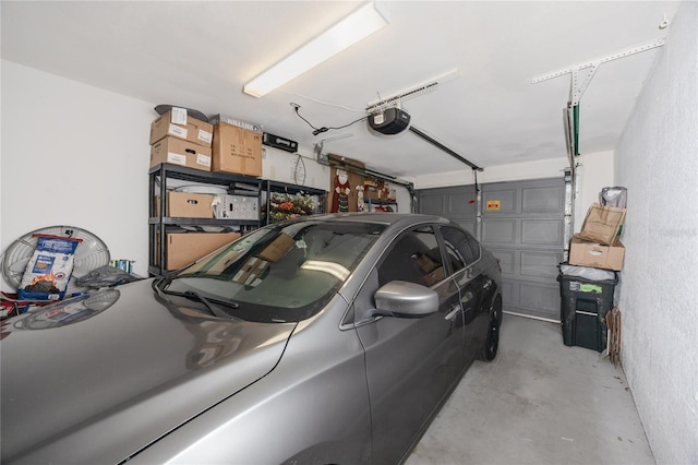 garage featuring a garage door opener and a textured wall