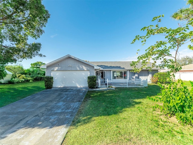 ranch-style house with covered porch, a garage, and a front lawn