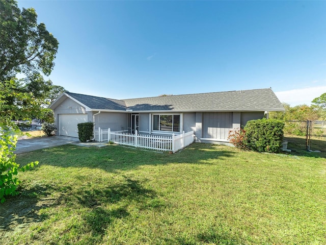 ranch-style house featuring covered porch, a garage, and a front lawn