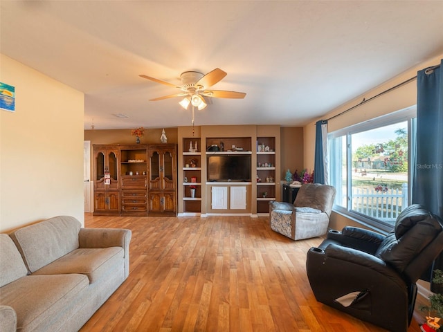 living room with hardwood / wood-style floors and ceiling fan