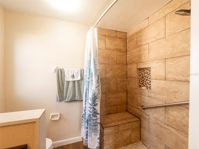 bathroom with toilet and curtained shower