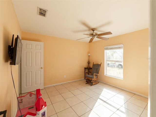 unfurnished room featuring ceiling fan and light tile patterned floors