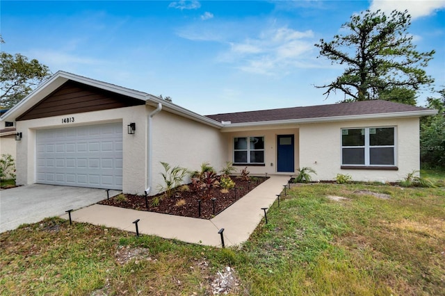 ranch-style home with a garage and a front yard