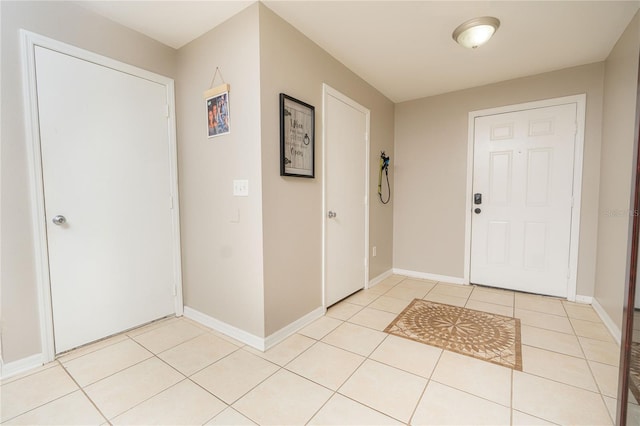 foyer entrance featuring light tile patterned flooring