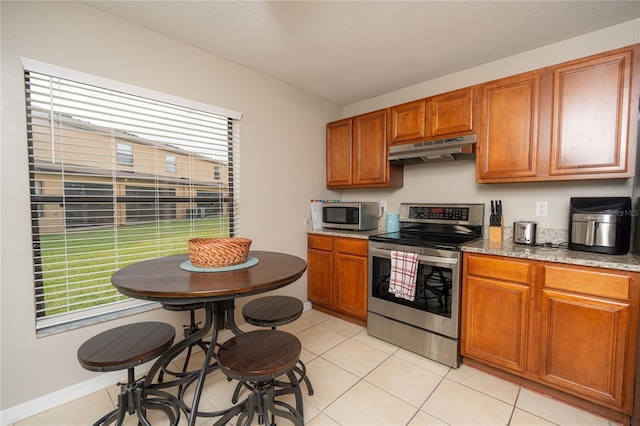 kitchen featuring light tile patterned floors and appliances with stainless steel finishes