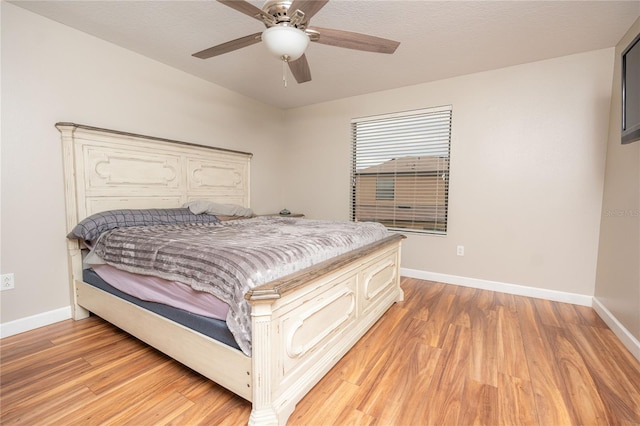 bedroom featuring ceiling fan, a textured ceiling, and light wood-type flooring