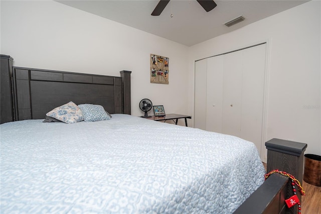 bedroom with wood-type flooring, a closet, and ceiling fan