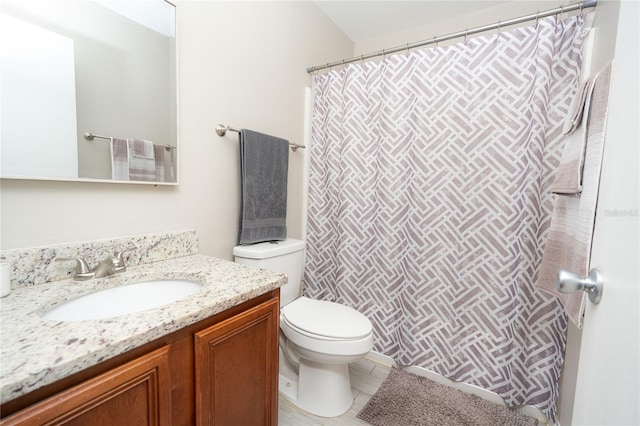 bathroom with tile patterned flooring, vanity, and toilet